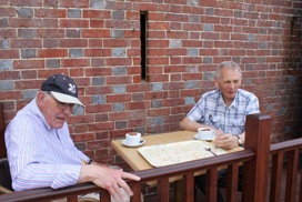 Andrew and Roger enjoy morning tea and biscuits